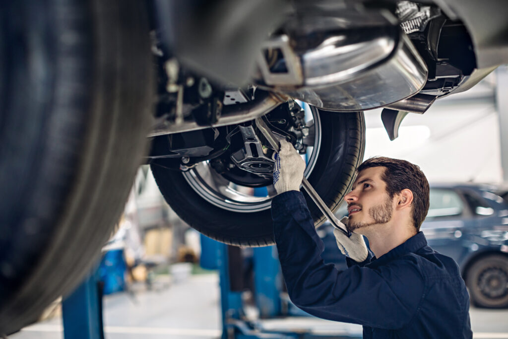 Car mechanic working on break disk